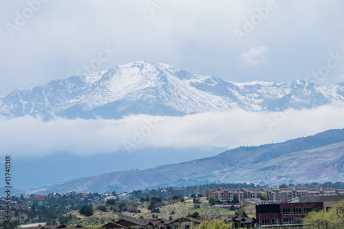 Colorado icy and crisp powder blue mountain with fallen clouds