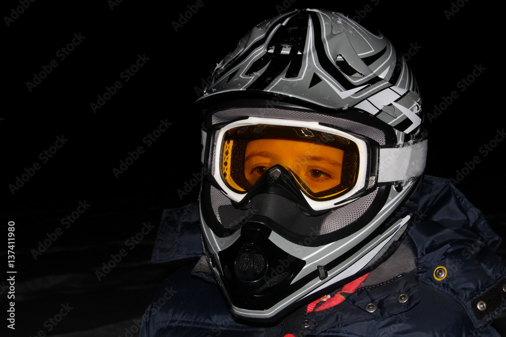 Child Wearing an ATV Helmet at Night
