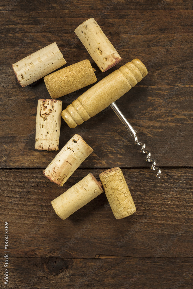 Photo of wine corkscrew and cork on dark background