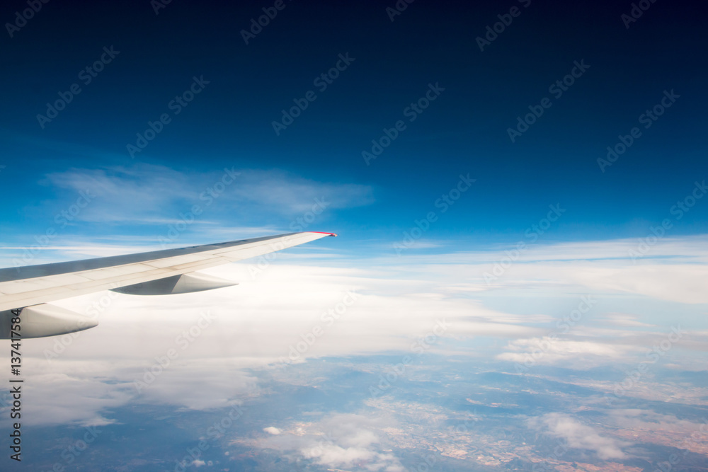 Fototapeta premium The wing of an airplane flying in the sky