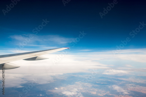 The wing of an airplane flying in the sky