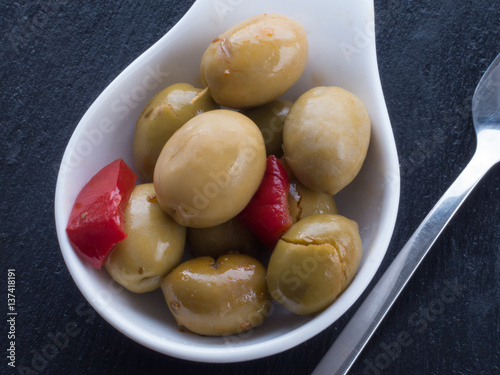 Green olives on black surface