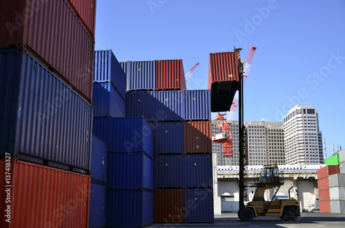 Toplifter handling cargo container loading to container trailer in import export logistic zone 