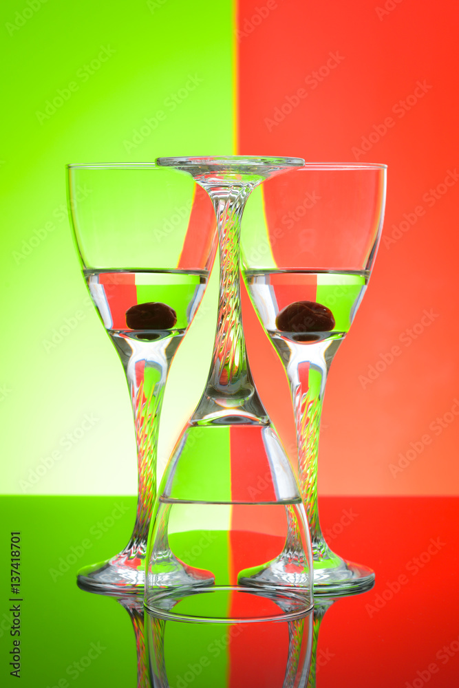 Wine glasses on glossy table surface and color background Wine glasses on glossy table surface and color background