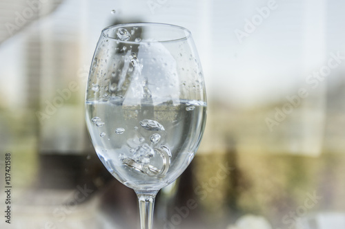 Wedding rings in champagne glass