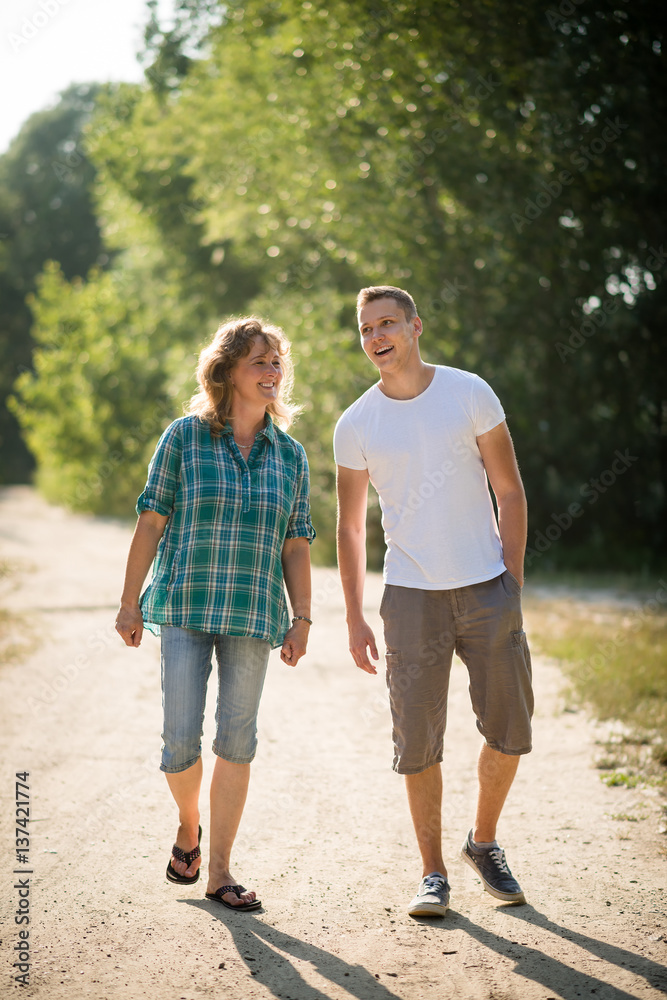 Son spending priceless time with his mother as they walk together Son spending priceless time with his mother as they walk together