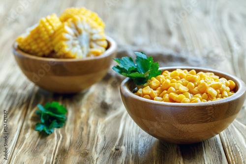 Canned sweet corn in a wooden bowl.