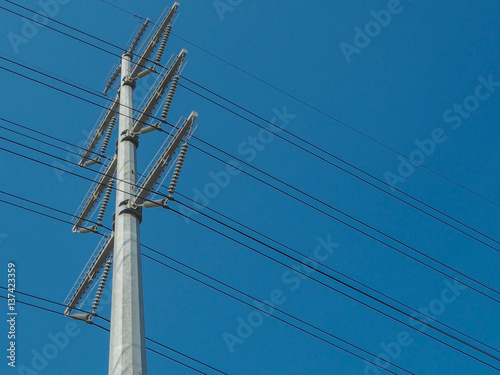 Electricity poles(New design) and wires on blue color background. © Freely