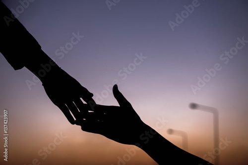 silhouette of helping hand concept