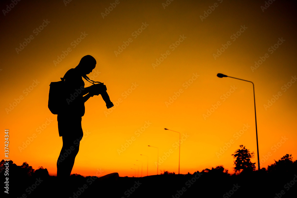 silhouette of a photographer who shoots a sunset. silhouette of a photographer who shoots a sunset.