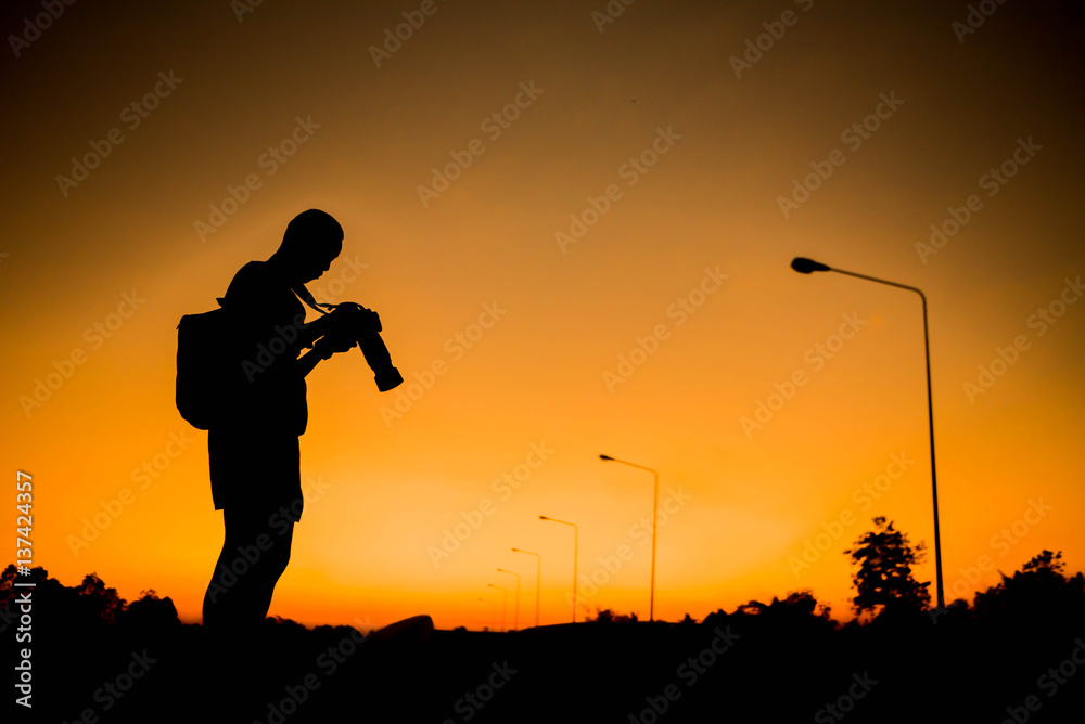 silhouette of a photographer who shoots a sunset. silhouette of a photographer who shoots a sunset.