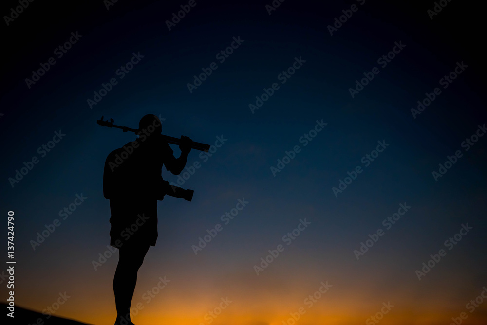 silhouette of a photographer who shoots a sunset. silhouette of a photographer who shoots a sunset.