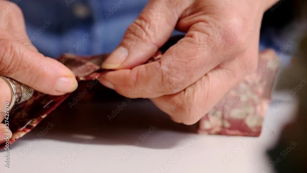 Closeup hands of seamstress at work with cloth fabric Closeup hands of seamstress at work with cloth fabric