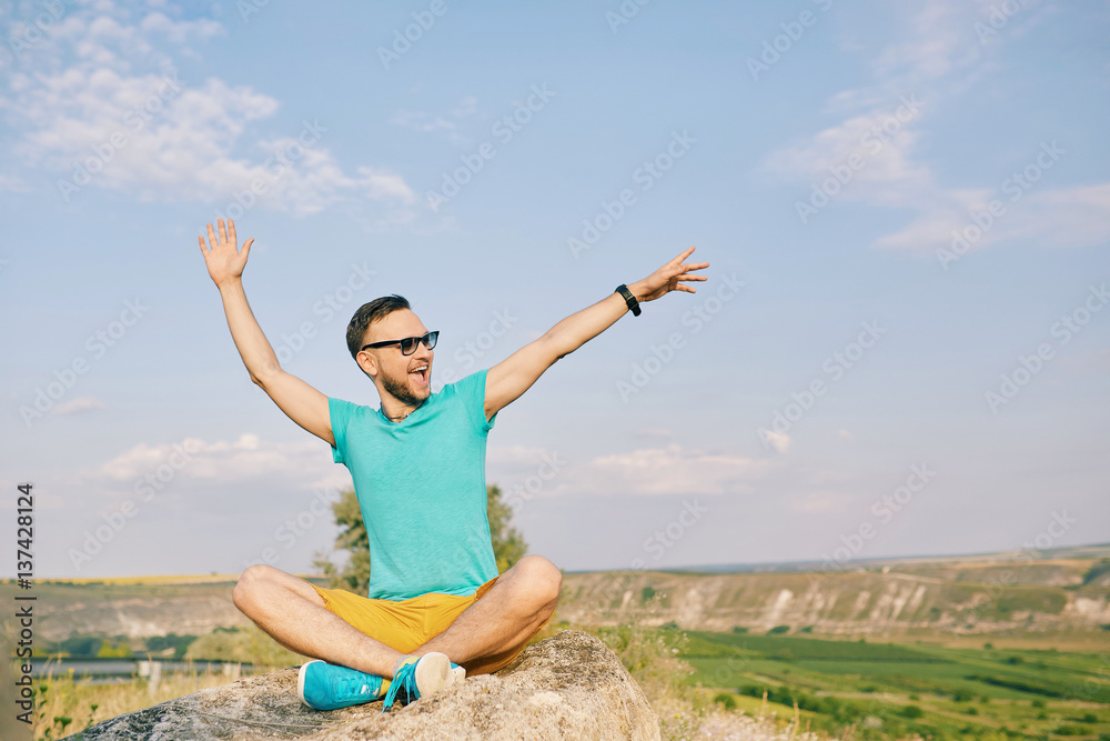 Young man smiling and enjoying sunny summer day Young man smiling and enjoying sunny summer day