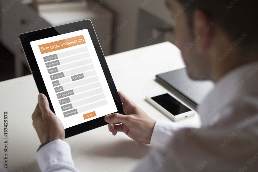 Businessman looking an online personal infortion form with tablet pc