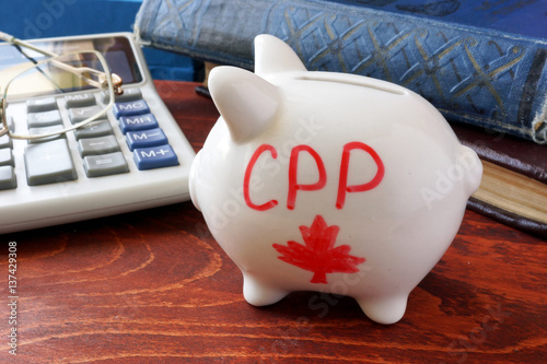 Piggy bank with word CPP. Canada Pension Plan concept. photo