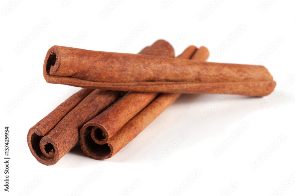 three cinnamon sticks isolated on white background