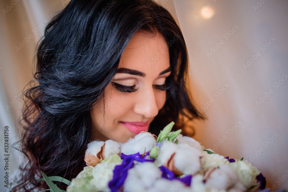Brunette lady closes her eyes with long eyelashes smelling wedding bouquet Brunette lady closes her eyes with long eyelashes smelling wedding bouquet