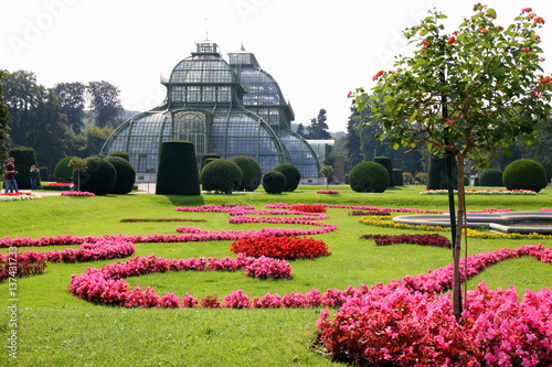 Travel to Vienna, Austria. The view on park with buildings, trees and colorful flowers.