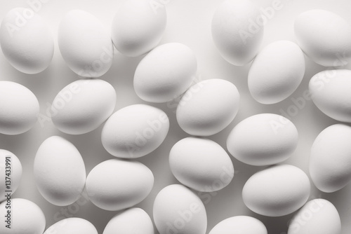White eggs make pattern on white background