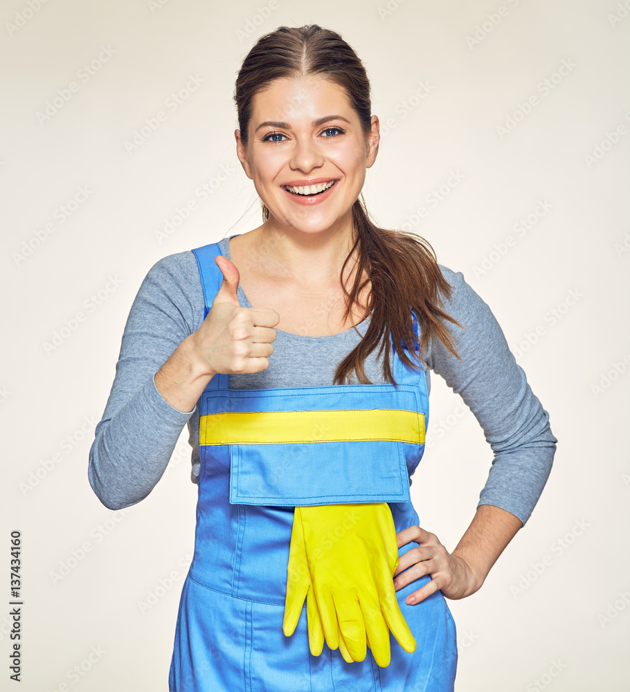 Smiling woman cleaner worker shows thumb up. Smiling woman cleaner worker shows thumb up.