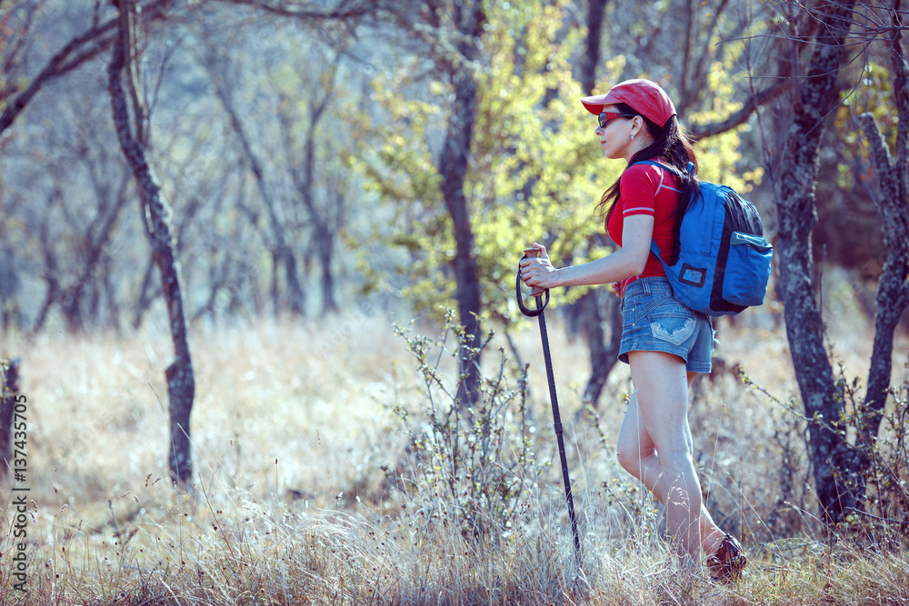 Young traveler with backpack standing on the big stones Young traveler with backpack standing on the big stones