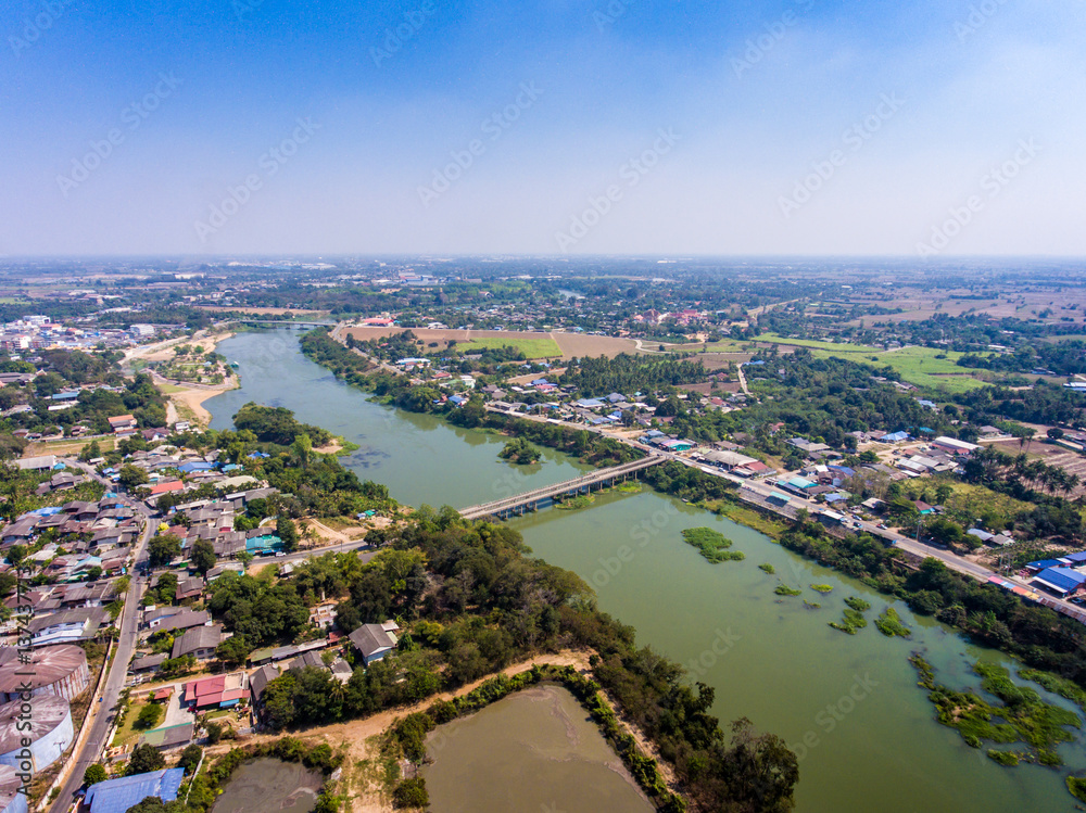 Aerial view of rural area landscape with tranquil village and river