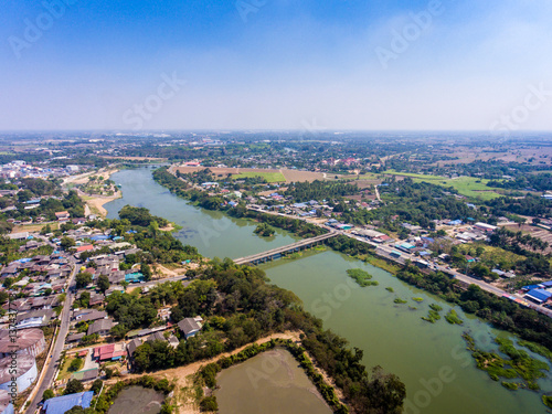 Aerial view of rural area landscape with tranquil village and river