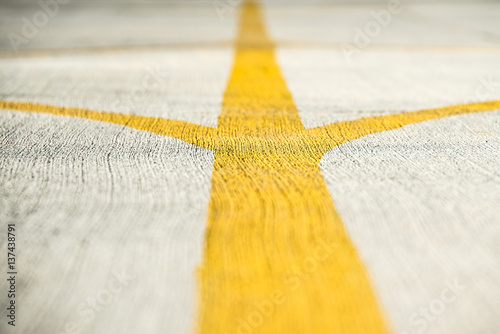 Fotografija Yellow direction strips closeup on an airfield runway.