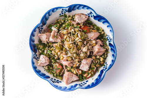 Ceramic bowl with wavy edges salad with beans and chicken photo