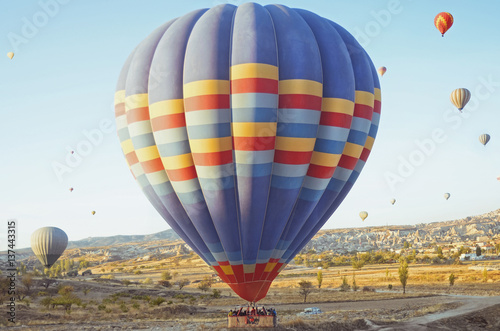 Colorful hot air balloon flying over the valley at Cappadocia, Turkey. Volcanic mountains in Goreme national park