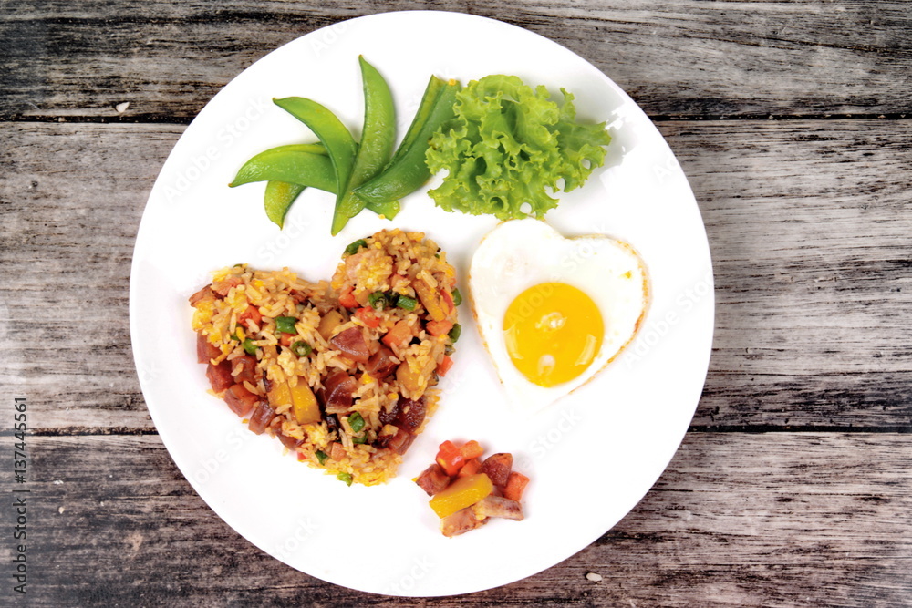 Chinese sausage fried rice and sunny egg in heart shapes. Chinese sausage fried rice and sunny egg in heart shapes.