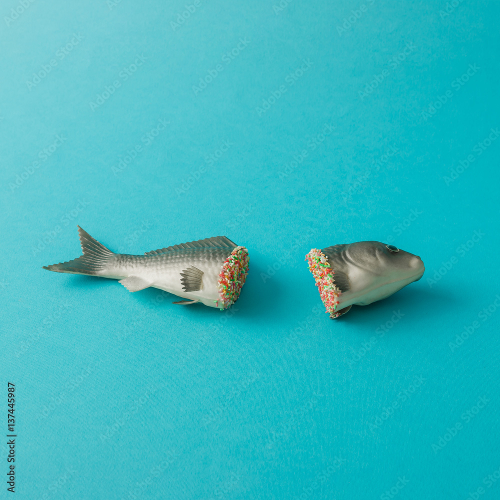 Fish cut in half with colorful sprinkles. Minimal food concept. Stock