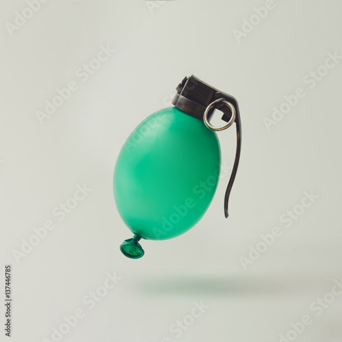 Balloon hand grenade bomb on white background. Minimal party concept.