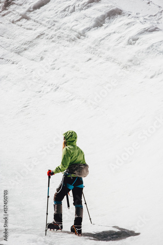 Traveler climbing to mountain summit Travel Lifestyle concept adventure active vacations outdoor mountaineering sport alpinism equipment crampons on glacier