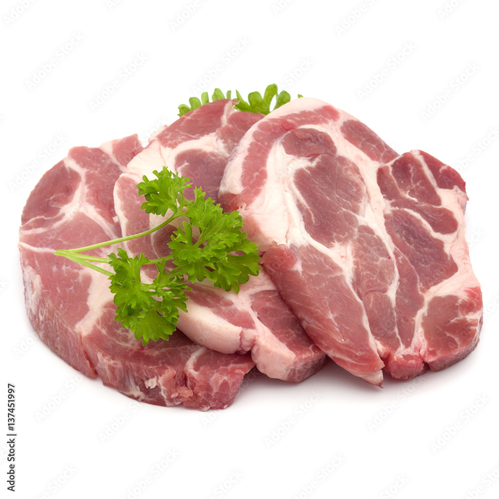 Raw pork neck chop meat with parsley herb leaves garnish isolated on white background cutout Raw pork neck chop meat with parsley herb leaves garnish isolated on white background cutout