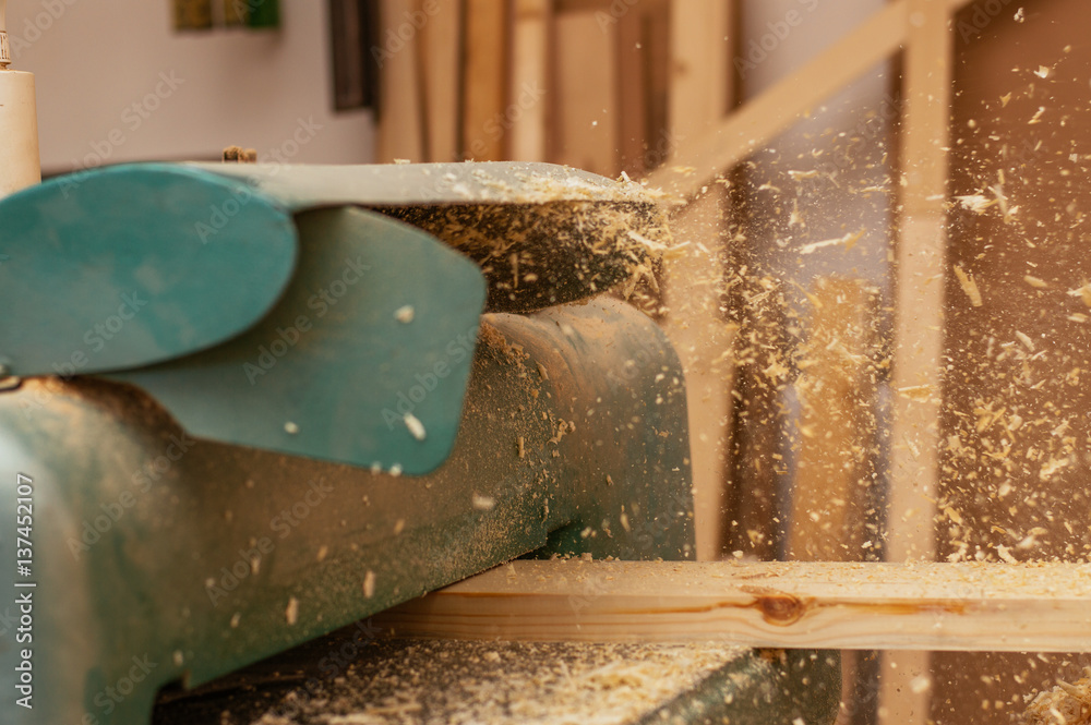 Carpenter working in a dusty workshop Carpenter working in a dusty workshop
