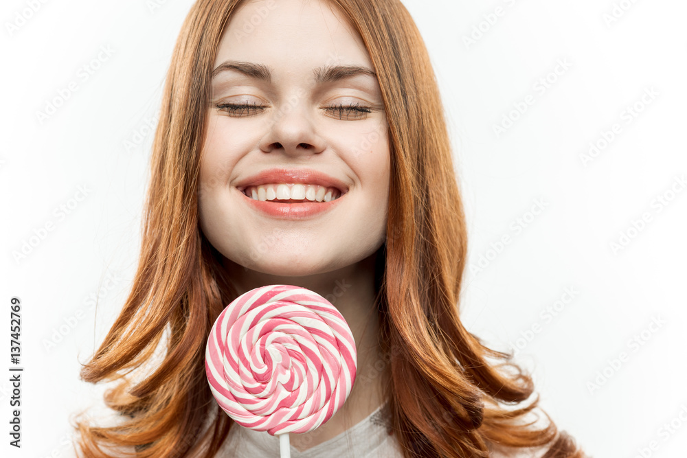 round lollipop in the hands of a happy woman