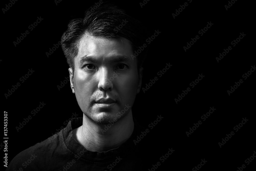 closeup asian handsome man face, black and white. isolated on black
