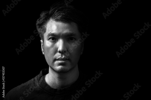 closeup asian handsome man face, black and white. isolated on black