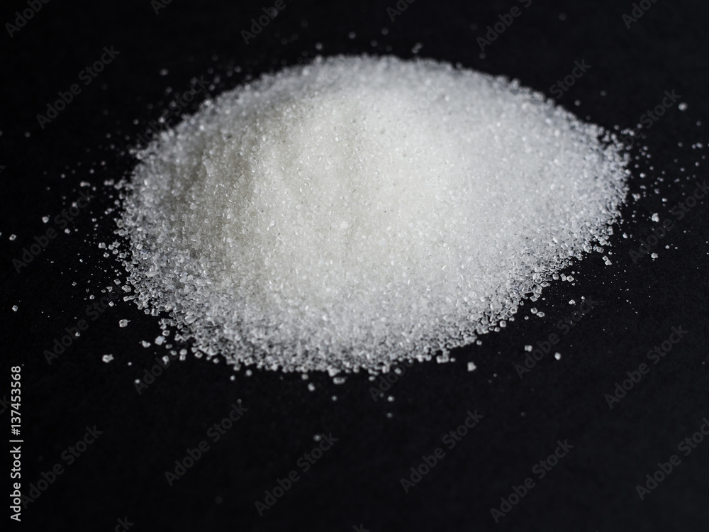 Sugar in a pile isolated on black background
