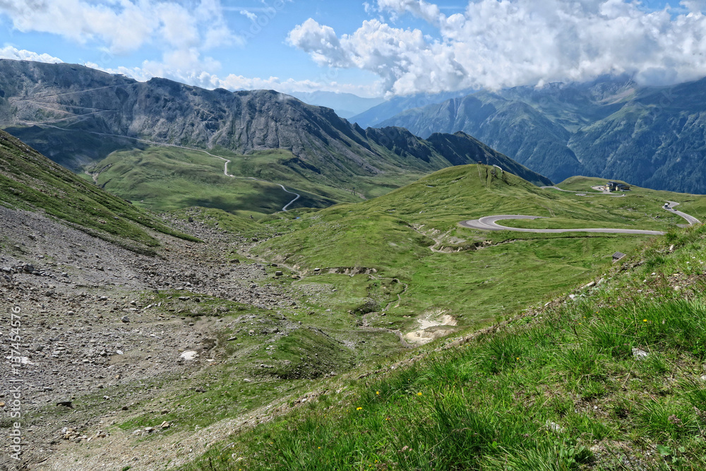  cars driving along the Grossglockner High Alpine Road in Austria at summer time.