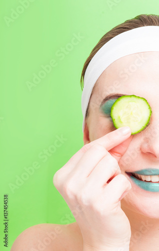 Woman with cucumber slice on eyes