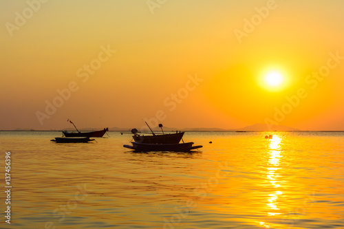 Boat and the beach with sunset background © rprisarn