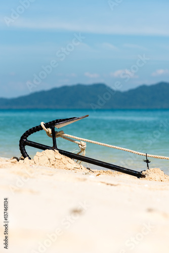 Detail of anchor of Thai longtail boat on beach sand
