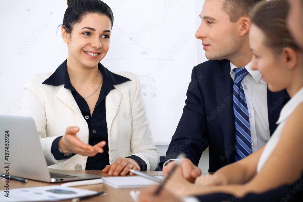 Group of business people and lawyers discussing contract papers at meeting Group of business people and lawyers discussing contract papers at meeting