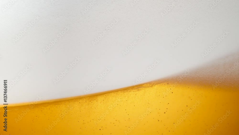 Extreme close-up beer in glass. Foam moving. Shot with high speed camera, phantom flex 4K. Slow Motion. Extreme close-up beer in glass. Foam moving. Shot with high speed camera, phantom flex 4K. Slow Motion.