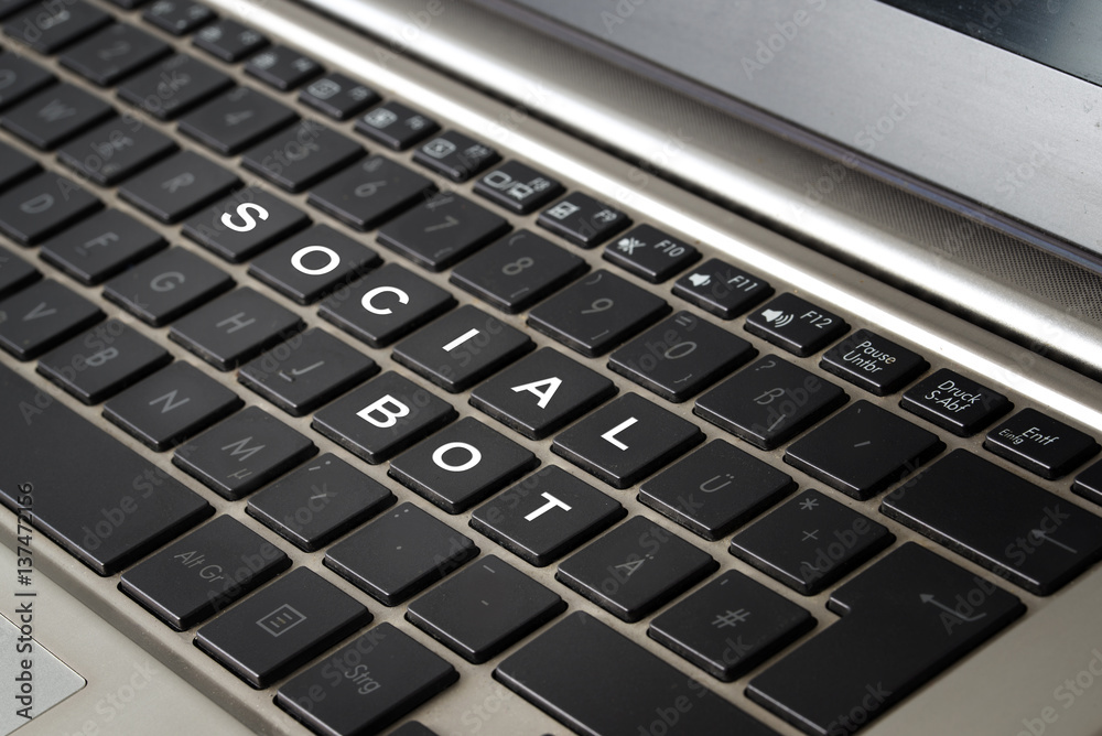 Computer laptop keyboard with the words SOCIAL BOT in white letters on black keys