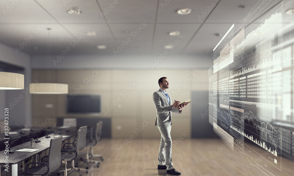Fototapeta premium Businessman in his office . Mixed media