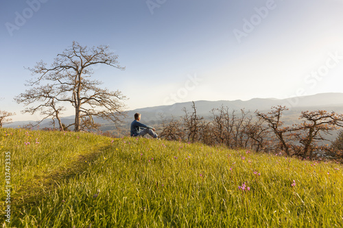 Man sitting at Mount Tzouhalem on Vancouver Island, Canada photo